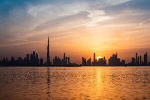 A picturesque shot of Dubai's iconic skyline featuring the Burj Khalifa during sunset, highlighting the luxurious lifestyle and attractions that resonate with Turkish travelers.